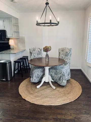 a dining room with table chairs and wooden floor