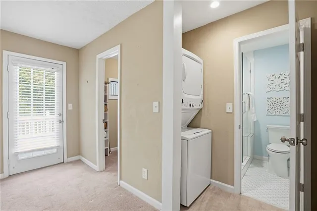 a view of bathroom with a toilet a sink and a mirror