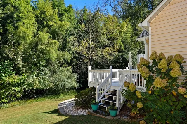 a view of a house with a yard and a tree