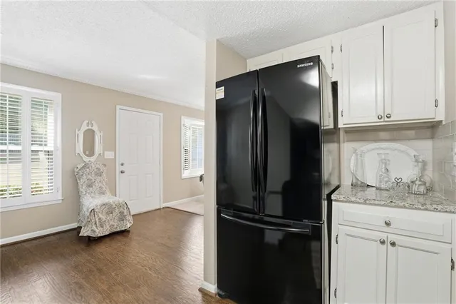 a kitchen with stainless steel appliances granite countertop a refrigerator and a stove top oven