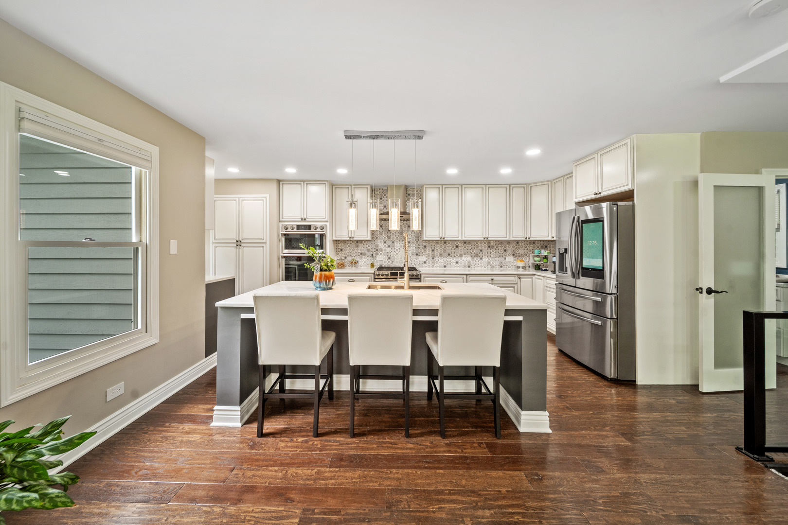 28W140 Mack Road Wheaton, IL 60189 - Photo 11 of 48 a kitchen with a table chairs refrigerator and a window