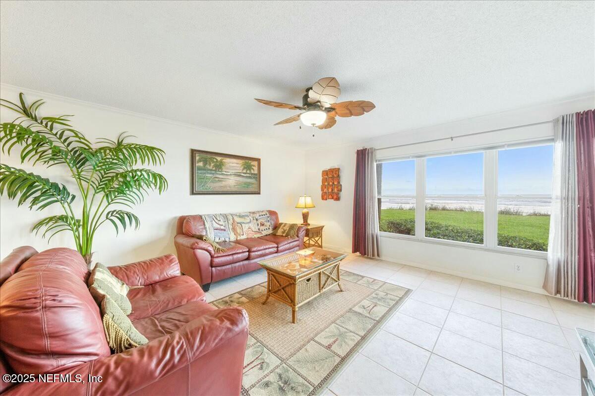 8090 Florida A1A, Unit 102 St. Augustine, FL 32080 - Photo 13 of 49 a living room with furniture and a large window with outer view