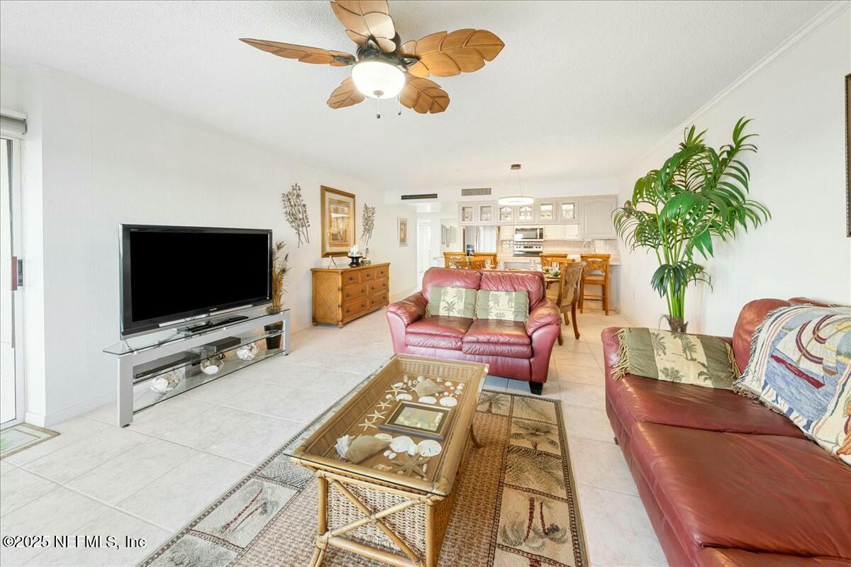 8090 Florida A1A, Unit 102 St. Augustine, FL 32080 - Photo 15 of 49 a living room with furniture and a flat screen tv