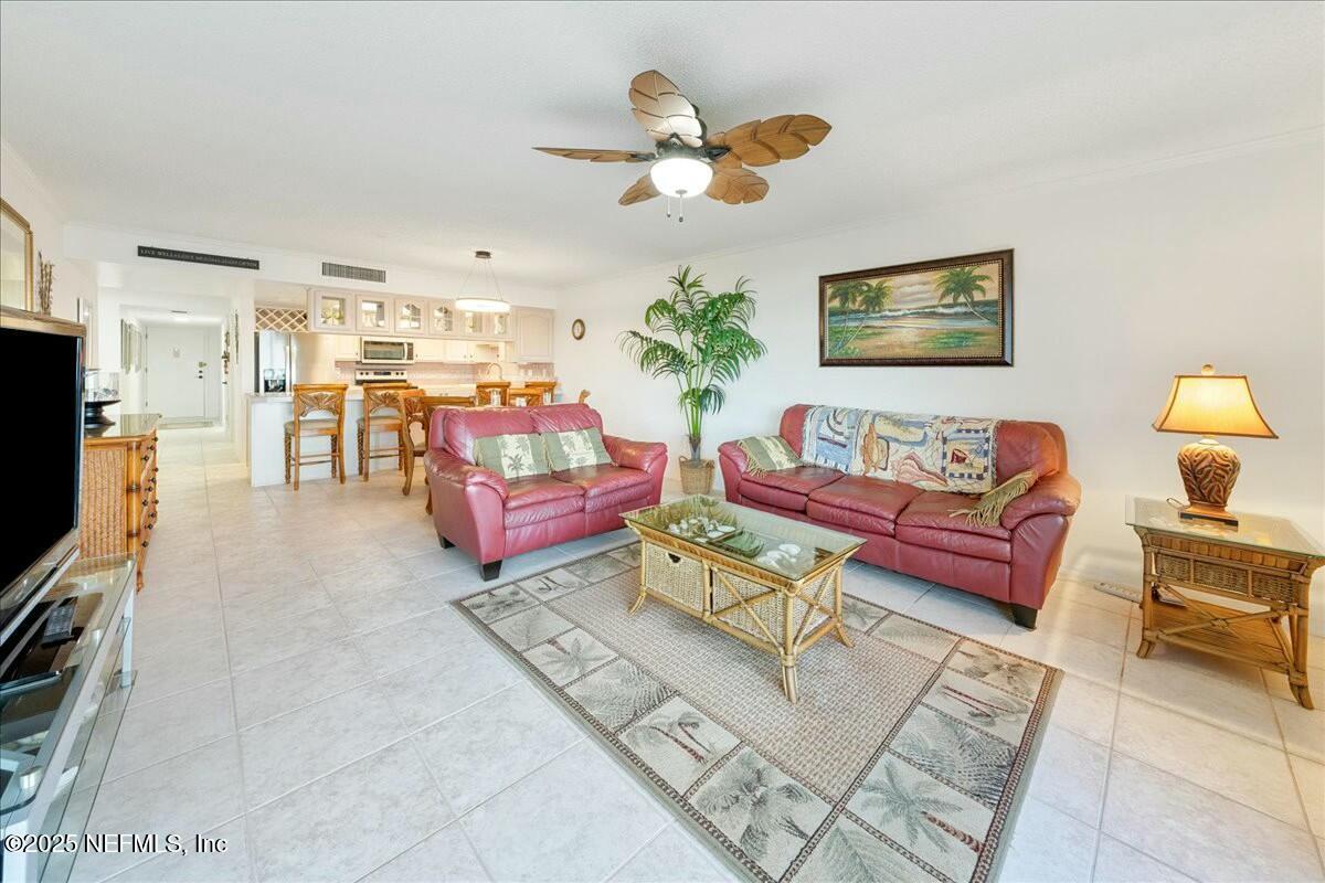 8090 Florida A1A, Unit 102 St. Augustine, FL 32080 - Photo 16 of 49 a living room with furniture and a flat screen tv