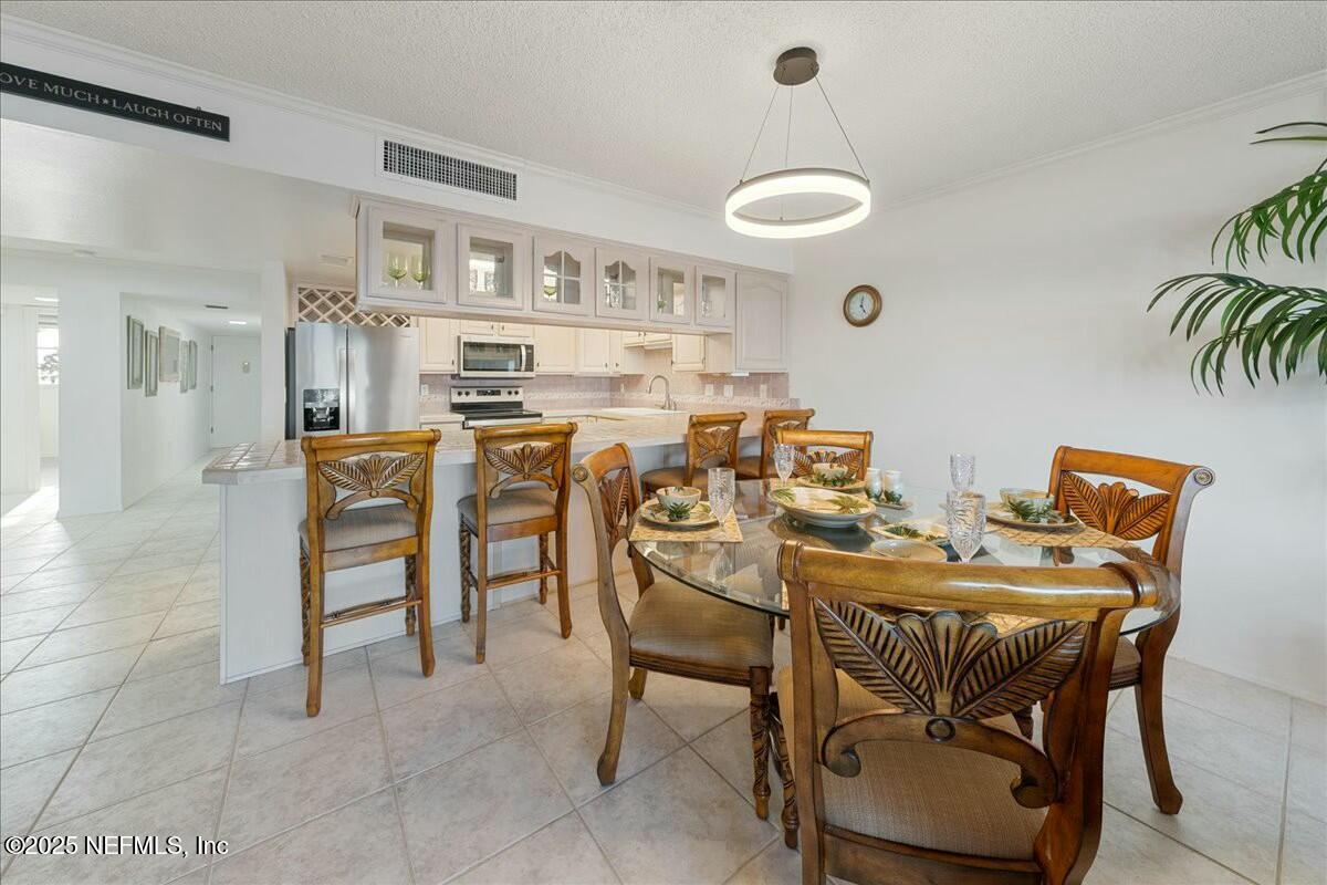 8090 Florida A1A, Unit 102 St. Augustine, FL 32080 - Photo 18 of 49 a view of a dining room with furniture