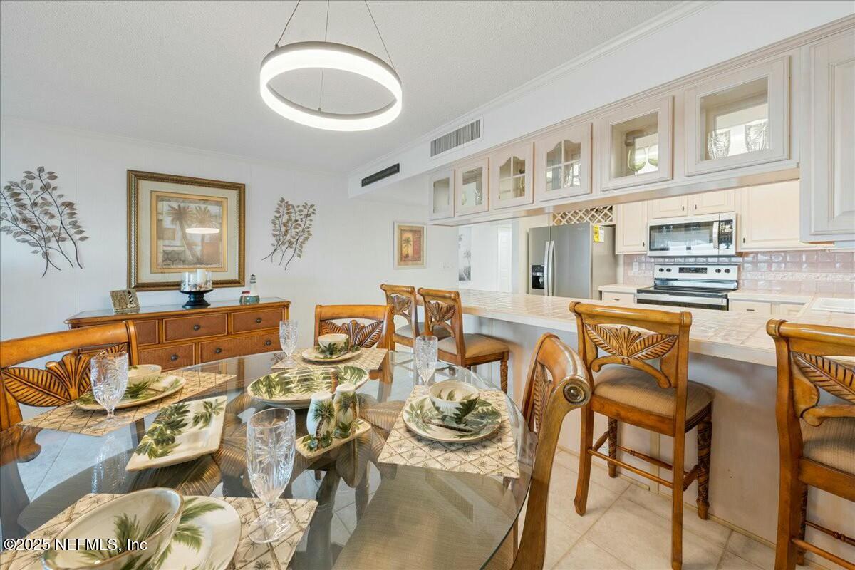 8090 Florida A1A, Unit 102 St. Augustine, FL 32080 - Photo 19 of 49 a view of a dining room with furniture and a kitchen