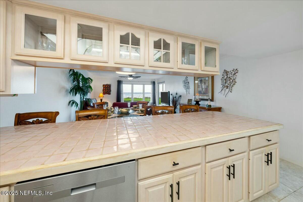 8090 Florida A1A, Unit 102 St. Augustine, FL 32080 - Photo 22 of 49 a view of a kitchen with stainless steel appliances granite countertop a living room