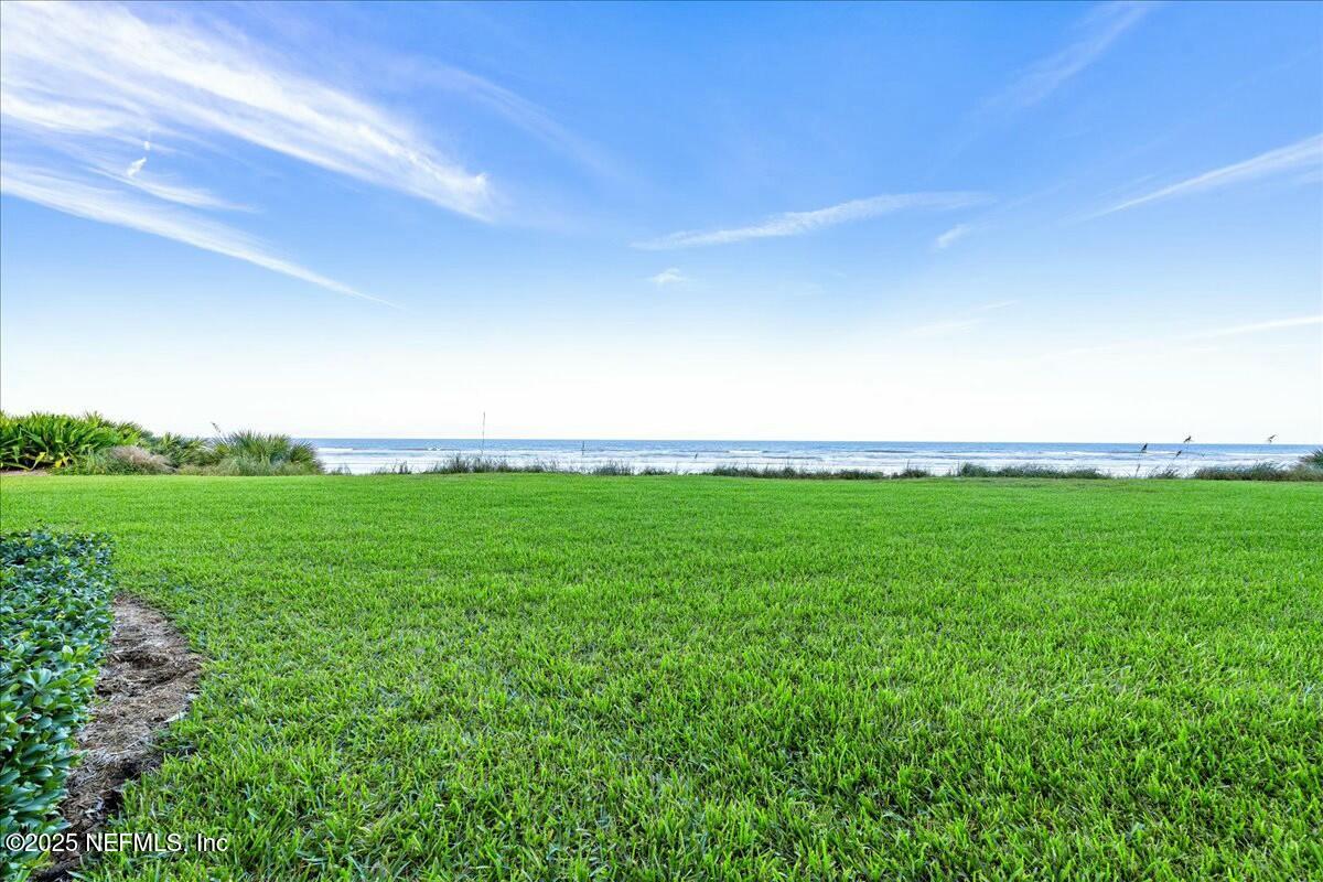 8090 Florida A1A, Unit 102 St. Augustine, FL 32080 - Photo 26 of 49 a view of a big yard with grass and plants