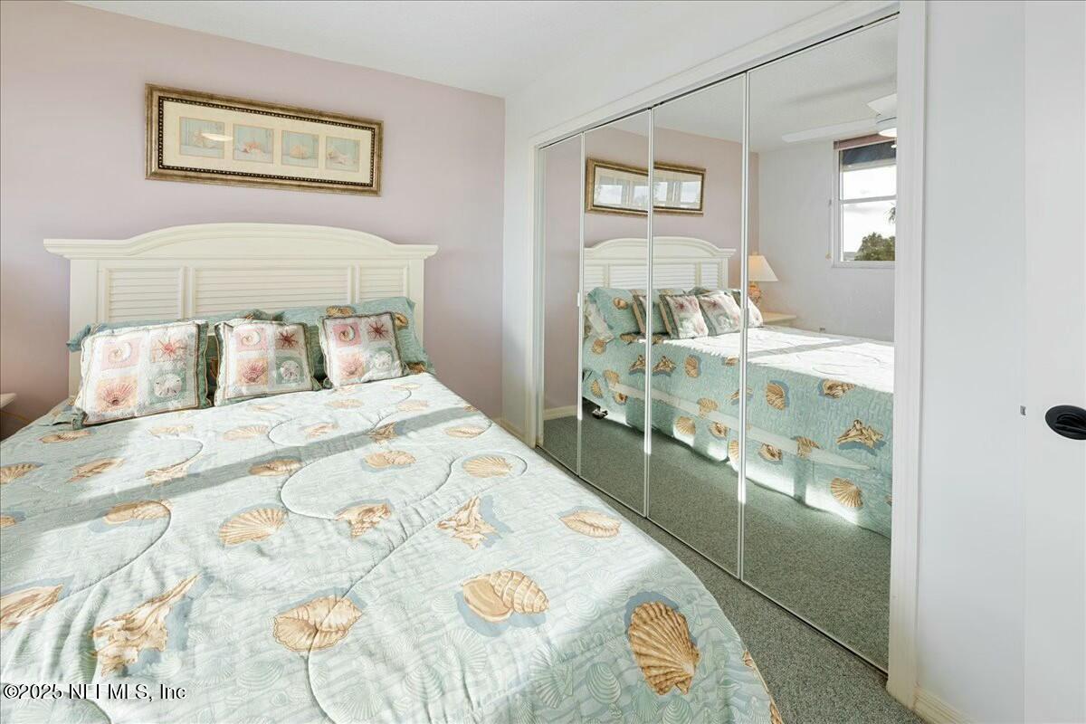 8090 Florida A1A, Unit 102 St. Augustine, FL 32080 - Photo 3 of 49 a bedroom with a bed and a view of bathroom