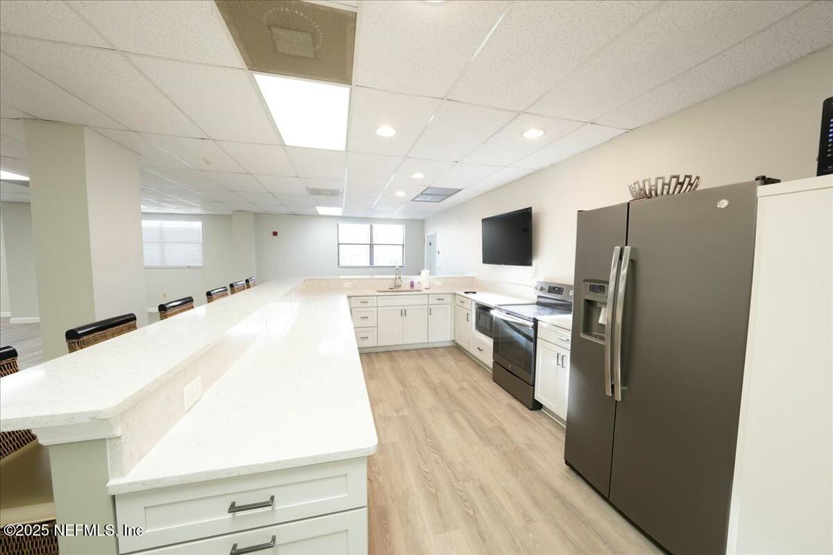 8090 Florida A1A, Unit 102 St. Augustine, FL 32080 - Photo 33 of 49 a large white kitchen with a large window