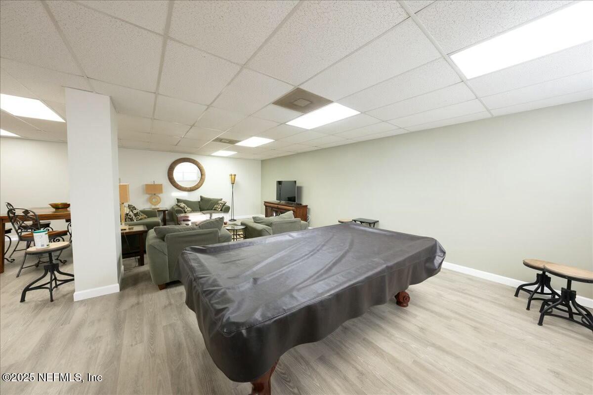 8090 Florida A1A, Unit 102 St. Augustine, FL 32080 - Photo 35 of 49 a living room with table and chairs