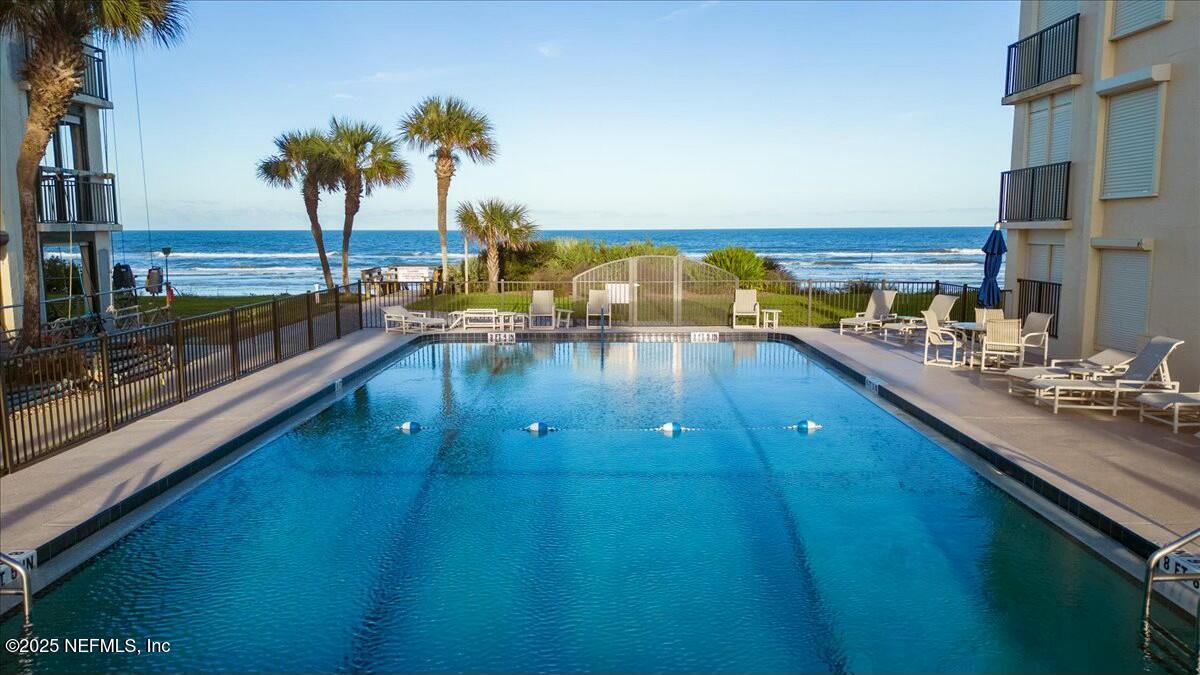 8090 Florida A1A, Unit 102 St. Augustine, FL 32080 - Photo 46 of 49 a view of a swimming pool and outdoor seating