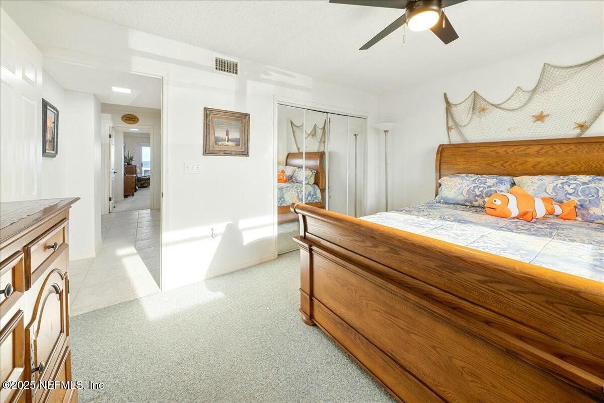8090 Florida A1A, Unit 102 St. Augustine, FL 32080 - Photo 6 of 49 a spacious bedroom with a bed and a couch