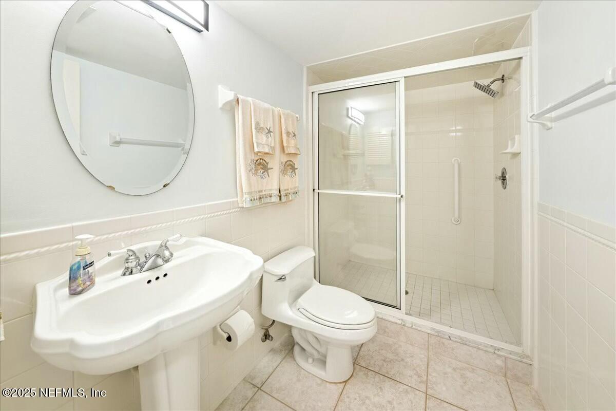 8090 Florida A1A, Unit 102 St. Augustine, FL 32080 - Photo 7 of 49 a bathroom with a sink toilet and shower