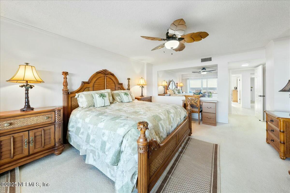 8090 Florida A1A, Unit 102 St. Augustine, FL 32080 - Photo 10 of 49 a spacious bedroom with a bed and a dresser