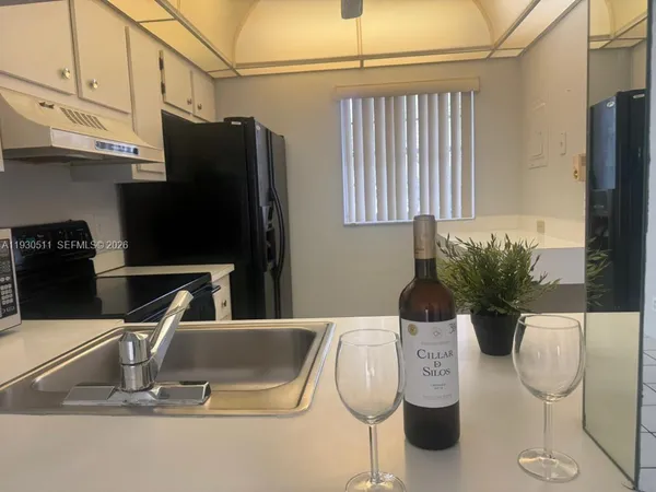 a kitchen with a table and chairs