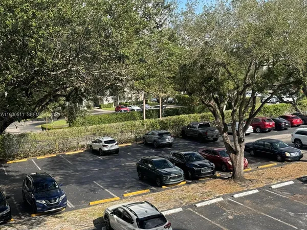a view of a street with cars parked