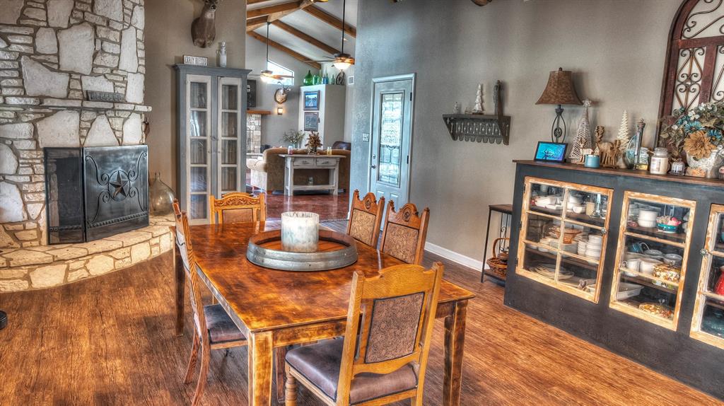 187 Roy Chisum Road Leakey, TX 78873 - Photo 20 of 40 a view of a dining room with furniture window and wooden floor