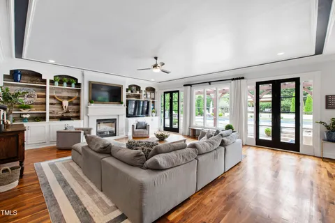 a kitchen with a refrigerator a stove and a wooden floor