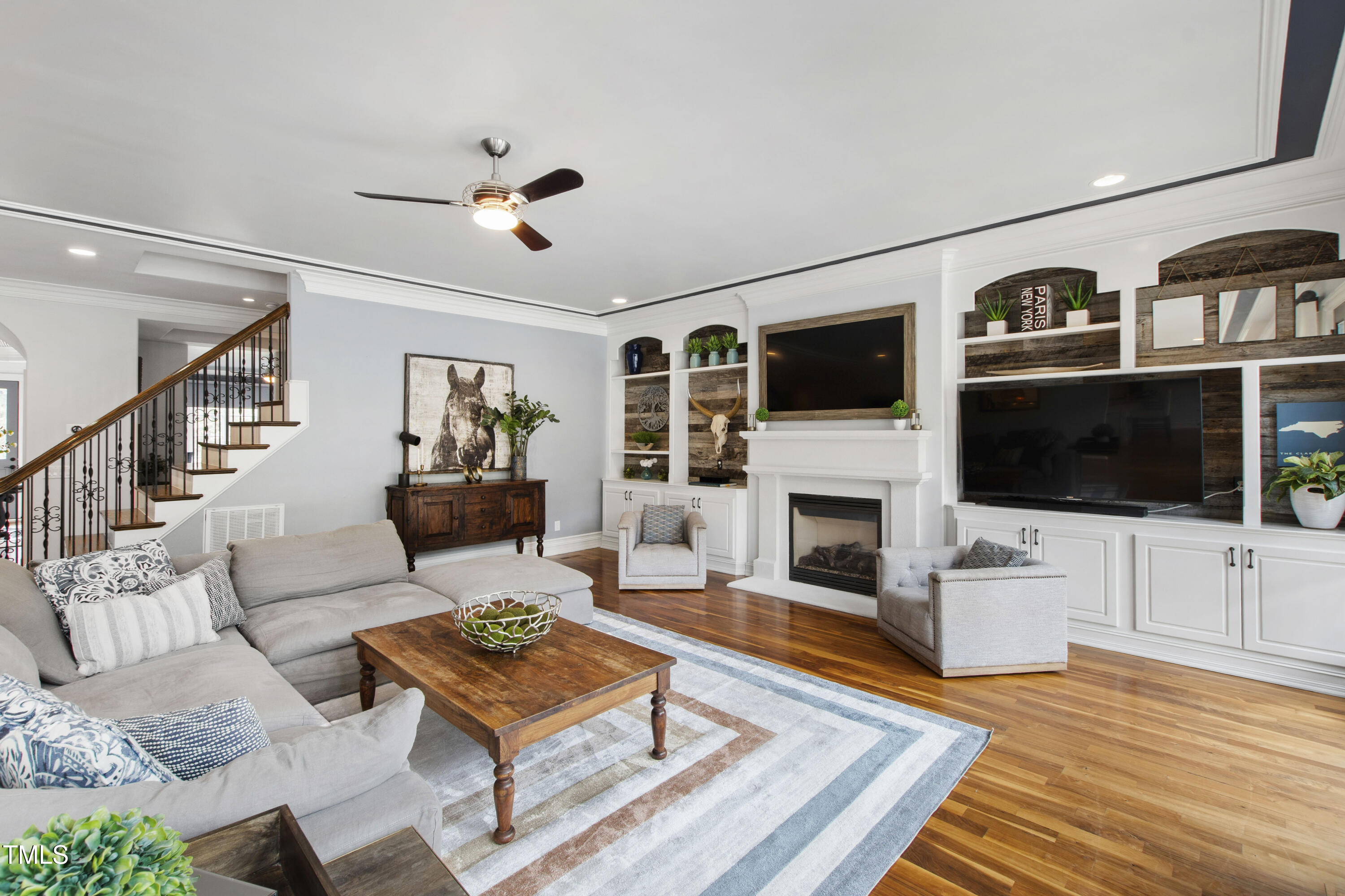 4725 Saratoga Falls Lane Raleigh, NC 27614 - Photo 17 of 97 a living room with furniture a flat screen tv and a fireplace