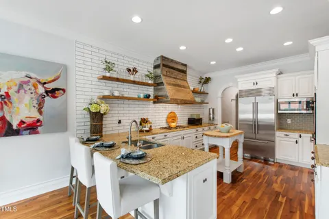 a view of a kitchen with a fireplace cabinets and a window