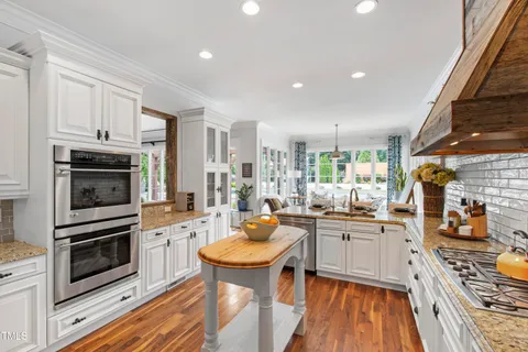 a living room with furniture a large window and a flat screen tv