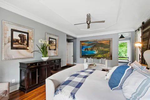 an empty room with a ceiling fan and window