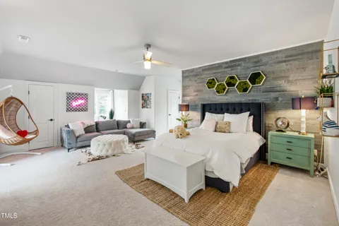 a front view of a house with a yard and potted plants