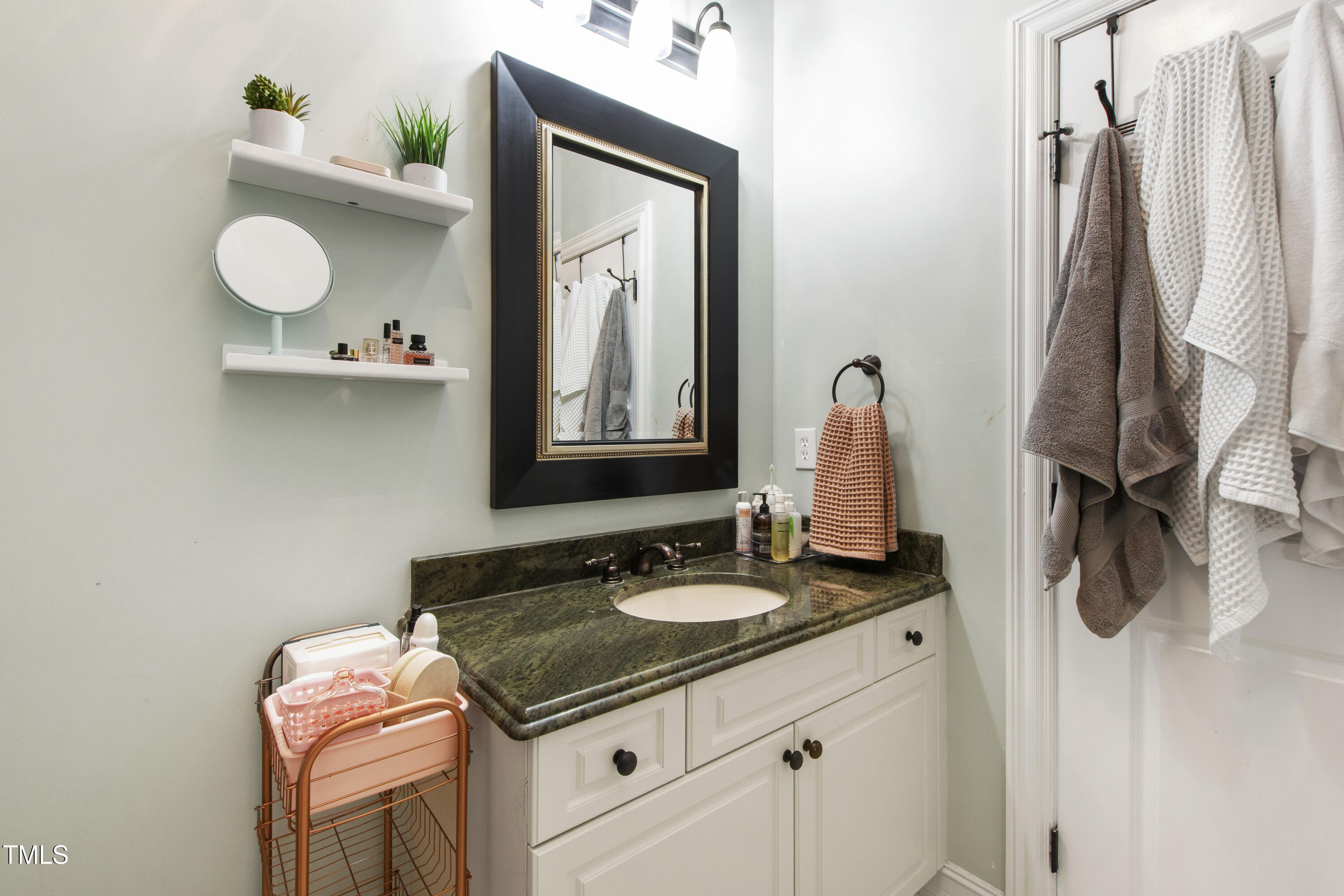 4725 Saratoga Falls Lane Raleigh, NC 27614 - Photo 52 of 97 a bathroom with a granite countertop sink and a mirror