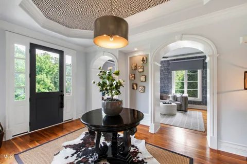 a living room with furniture potted plant and a chandelier
