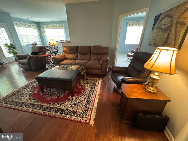 a view of a livingroom with furniture window and wooden floor