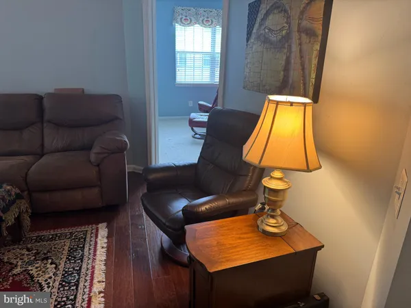 a living room with furniture and a lamp