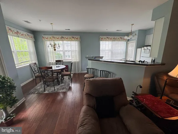 a bedroom with a bed and a flat tv screen on dresser