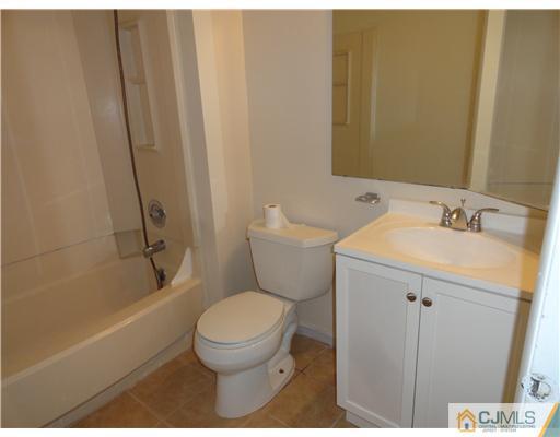36 Woodbury Road Edison, NJ 08820 - Photo 11 of 15 a bathroom with a sink toilet and shower
