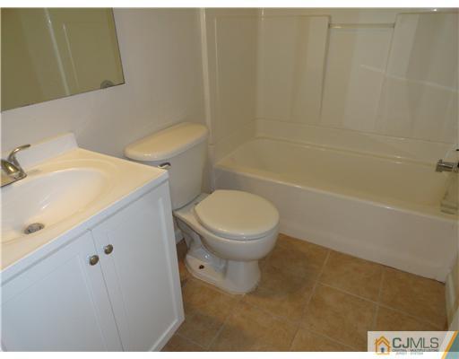 36 Woodbury Road Edison, NJ 08820 - Photo 13 of 15 a bathroom with a sink a toilet and shower