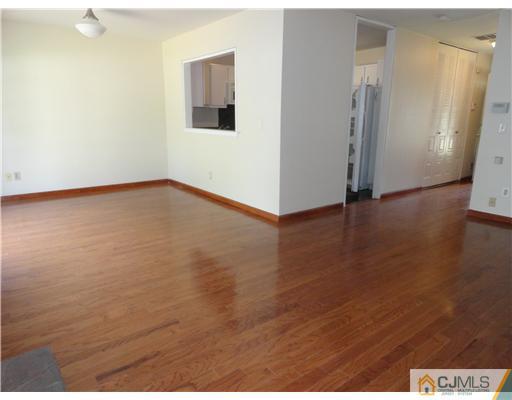36 Woodbury Road Edison, NJ 08820 - Photo 4 of 15 a view of an empty room with wooden floor and closet