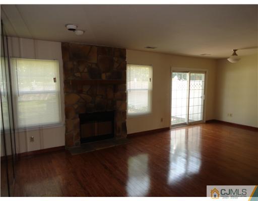 36 Woodbury Road Edison, NJ 08820 - Photo 5 of 15 a view of an empty room with wooden floor and a window