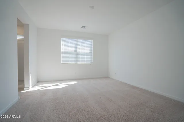 a view of an empty room with kitchen