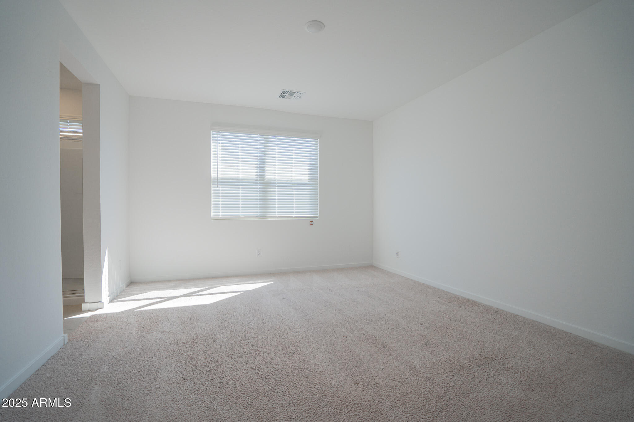 17317 West Running Deer Trail Surprise, AZ 85387 - Photo 16 of 37 a view of an empty room with a window