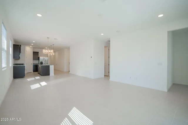 a large kitchen with kitchen island granite countertop a large counter top stainless steel appliances and cabinets