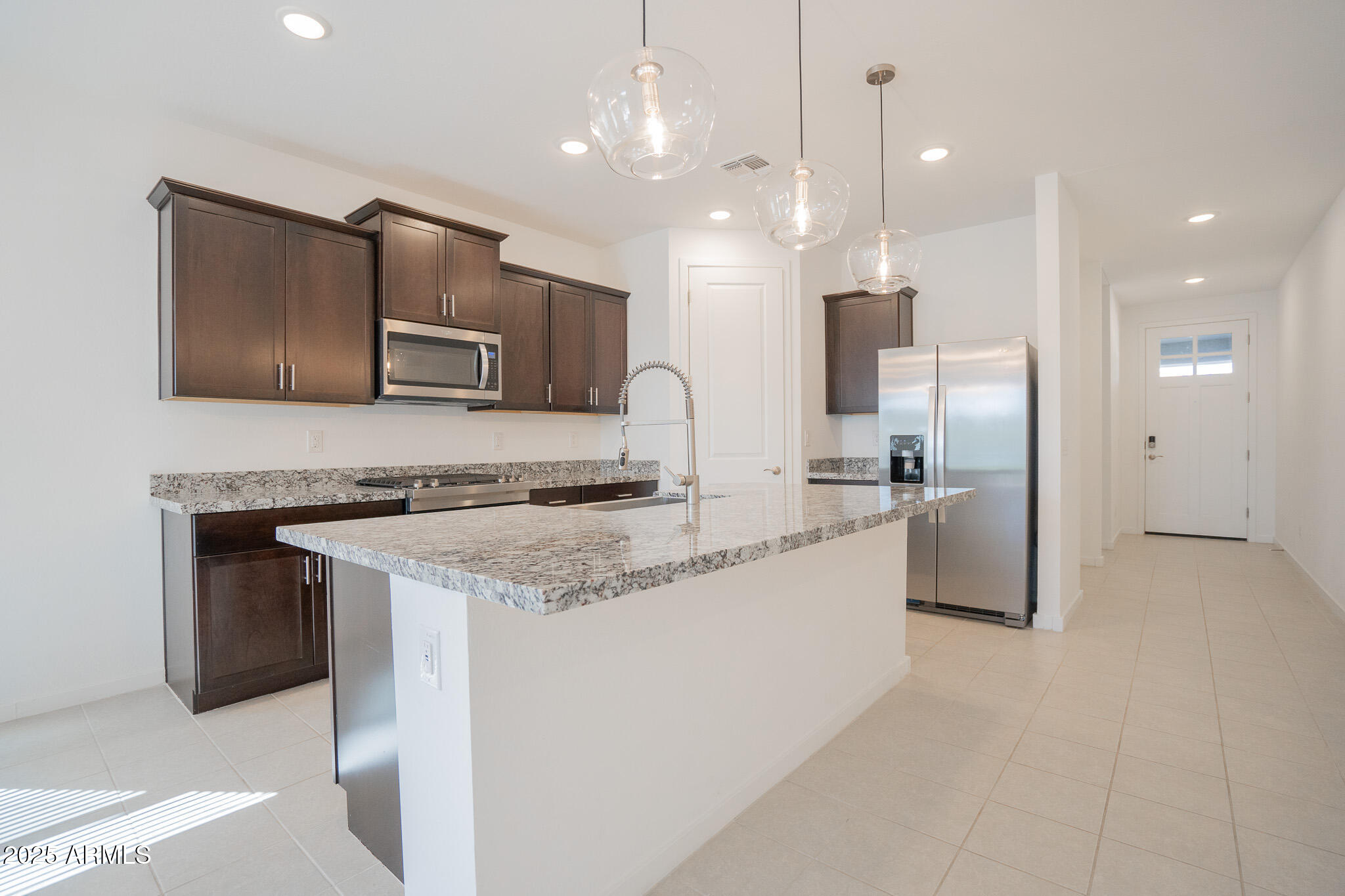 17317 West Running Deer Trail Surprise, AZ 85387 - Photo 7 of 37 a large kitchen with granite countertop a large counter top stainless steel appliances and cabinets