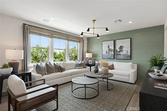 a living room with furniture potted plant and a large window