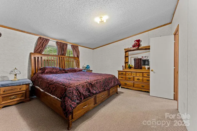 a bed sitting in a bedroom next to a window