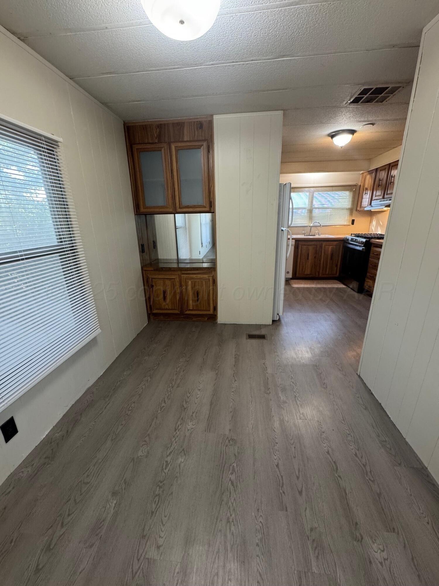 9705 Broadway Drive Amarillo, TX 79108 - Photo 6 of 10 a view of empty room with wooden floor