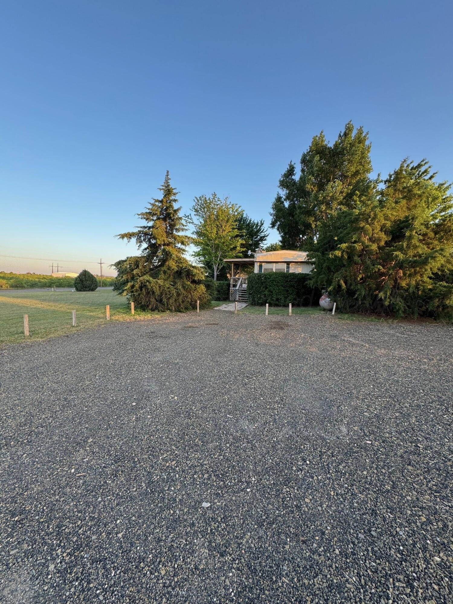 9705 Broadway Drive Amarillo, TX 79108 - Photo 7 of 10 a view of a field with large trees