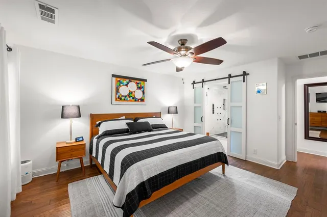 a bedroom with bed and a chandelier