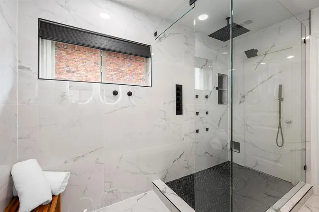 a bathroom with a bathtub and a shower