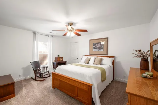 a living room with furniture and a bookshelf
