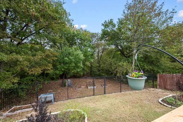 a backyard of a house with a fountain and potted plants