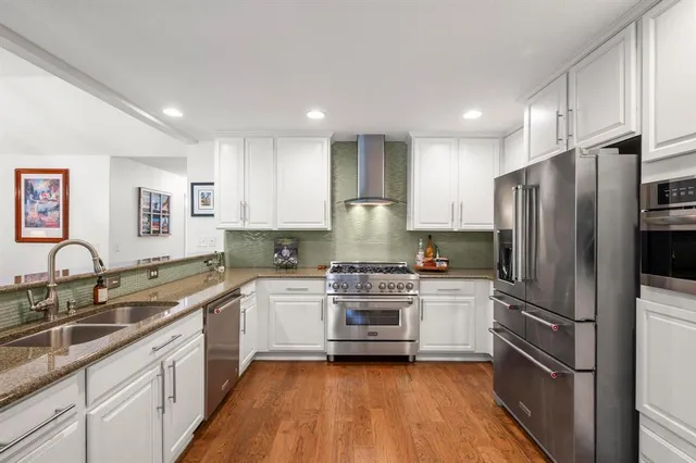 a kitchen with a refrigerator sink and stainless steel appliances